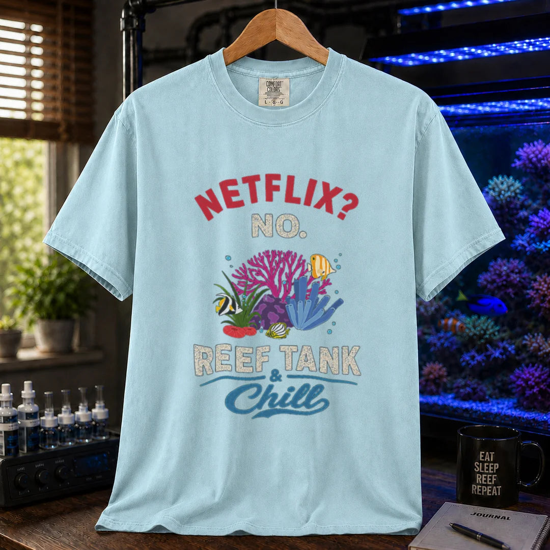 Saltwater aquarium graphic t-shirt featuring red and white typography reading Netflix? No. Reef Tank & Chill with a colorful coral and fish illustration, light blue crew neck tee
