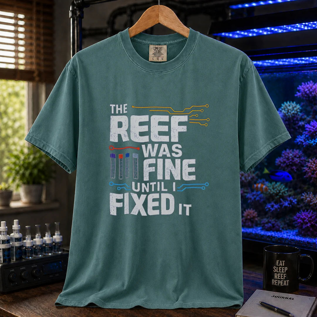 Saltwater aquarium graphic t-shirt featuring distressed white typography reading The Reef Was Fine Until I Fixed It with test vial icons and circuit lines, green crew neck tee