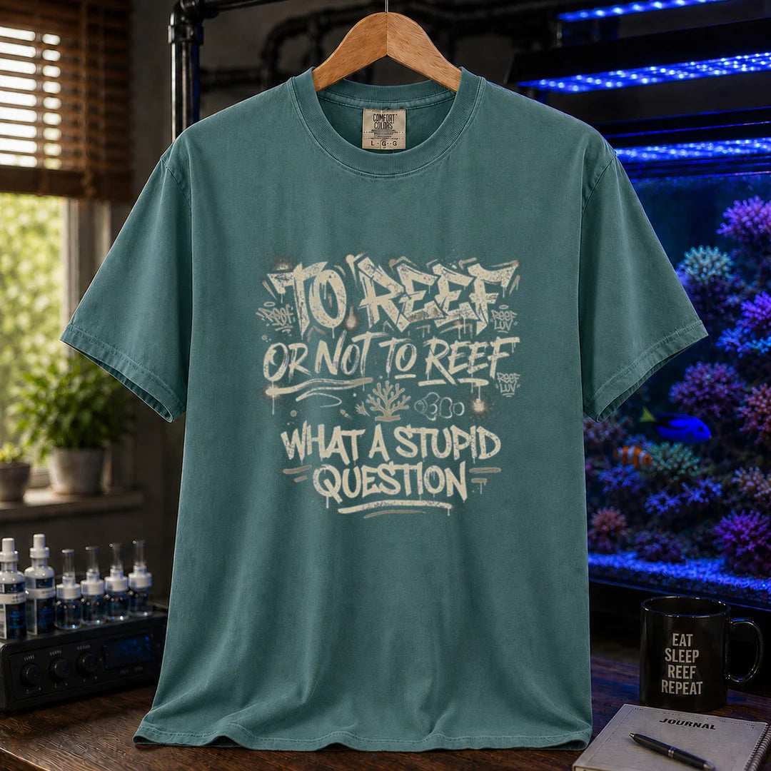 Saltwater aquarium graphic t-shirt featuring distressed white graffiti-style typography reading To Reef Or Not To Reef What A Stupid Question with coral and clownfish icons, green crew neck tee