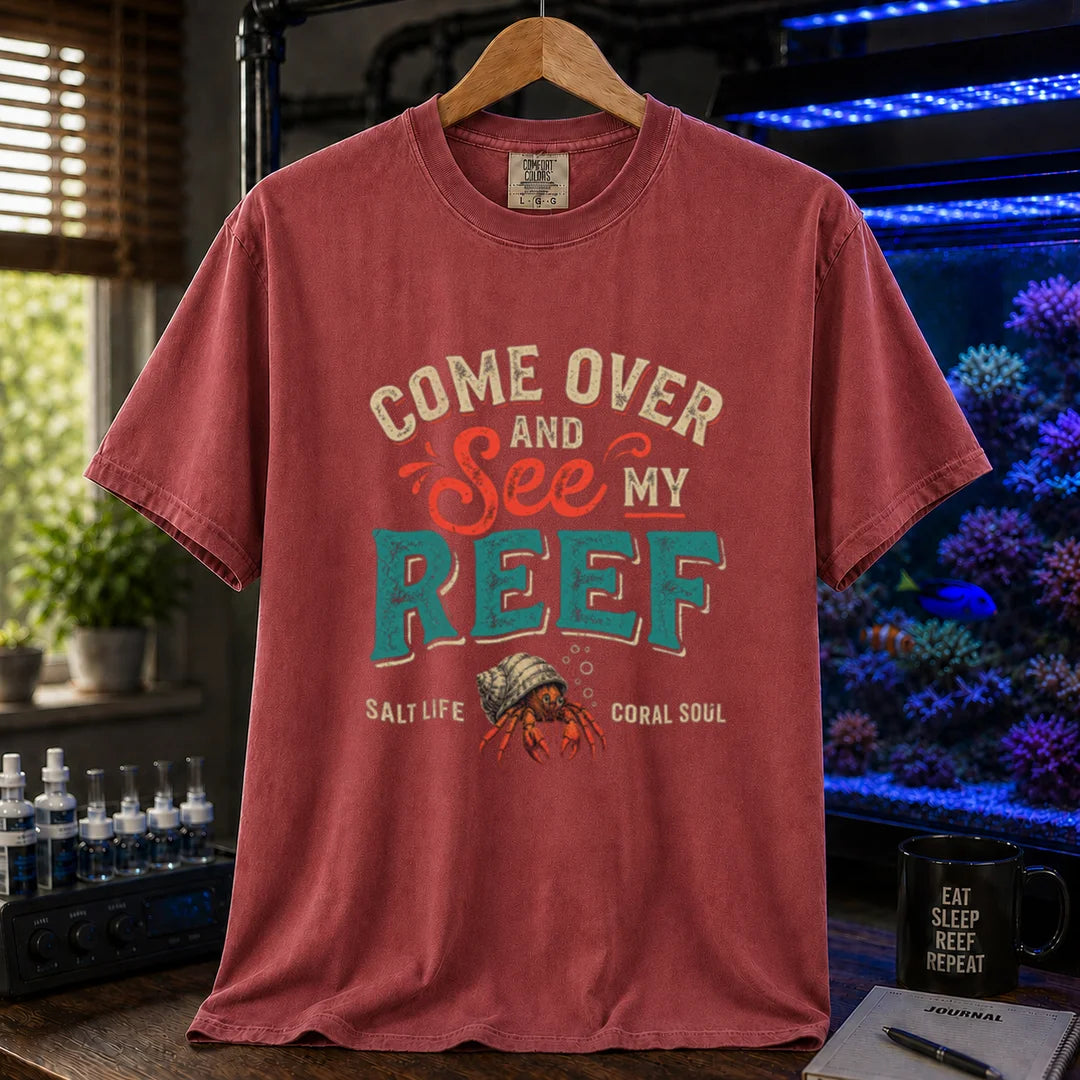 Saltwater aquarium graphic t-shirt featuring distressed retro typography reading Come Over And See My Reef with a hermit crab illustration and footer text, maroon, red crew neck tee