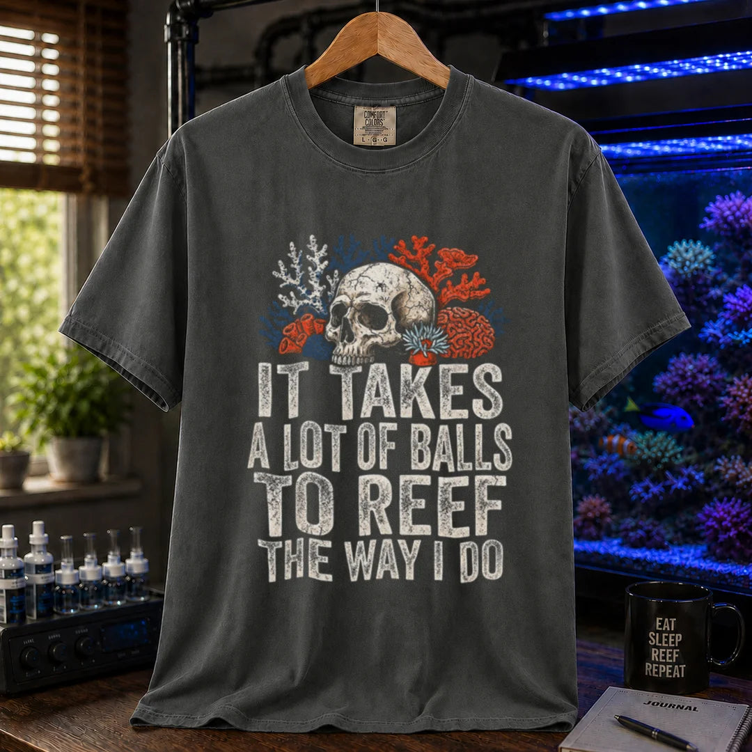 Saltwater aquarium graphic t-shirt featuring distressed white typography reading It Takes A Lot Of Balls To Reef The Way I Do with an illustration of a skull and coral formations, dark grey crew neck tee