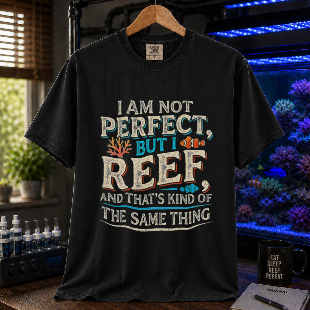 Saltwater aquarium graphic t-shirt featuring distressed multi-color typography reading I Am Not Perfect, But I Reef, And That's Kind Of The Same Thing with coral and clownfish graphics, black crew neck tee