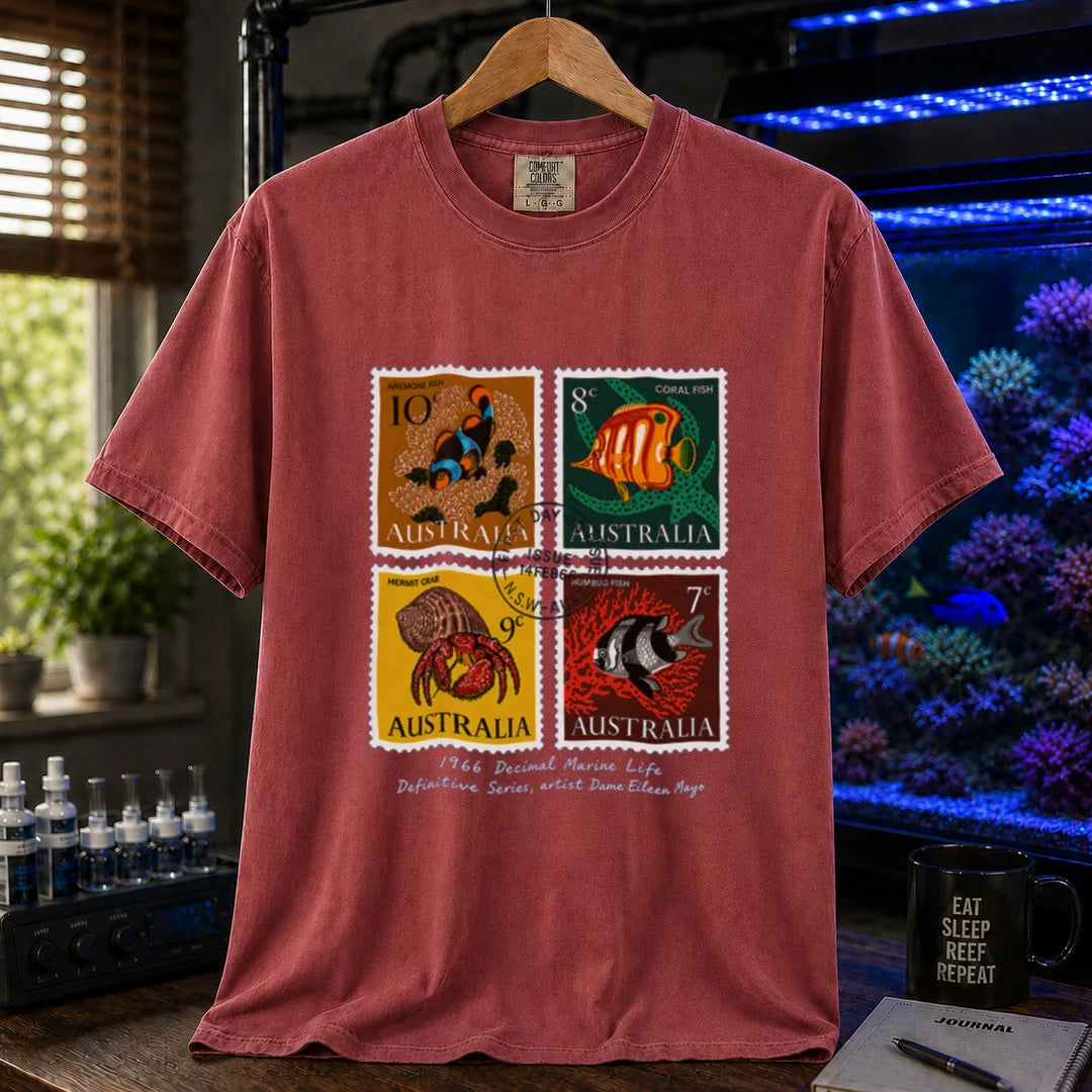Saltwater aquarium graphic t-shirt featuring a vintage block of four 1966 Australian marine life stamps designed by Dame Eileen Mayo with postmark and script text, maroon, red crew neck tee