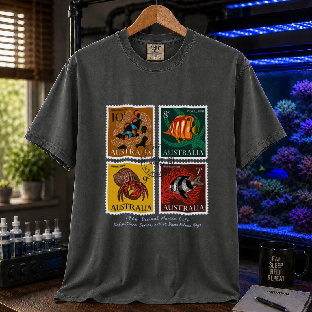 Saltwater aquarium graphic t-shirt featuring a vintage block of four 1966 Australian marine life stamps designed by Dame Eileen Mayo with postmark and script text, dark grey crew neck tee