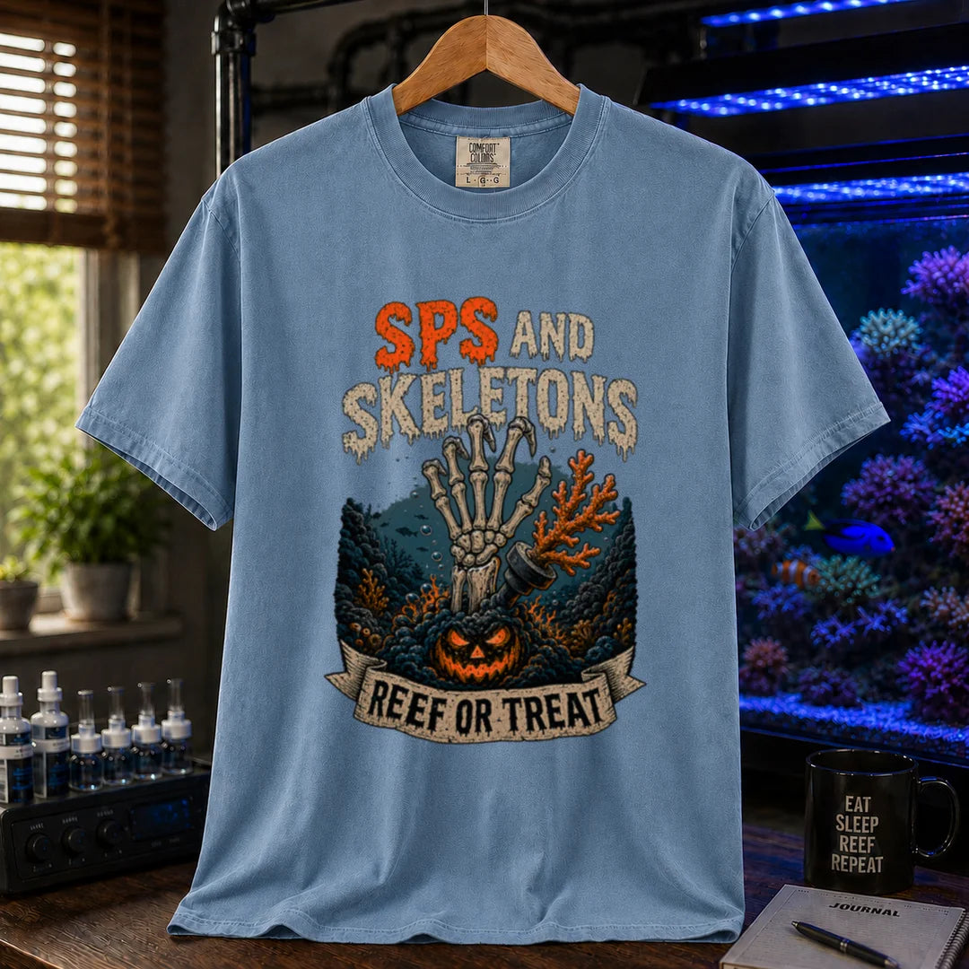 Saltwater aquarium graphic t-shirt featuring orange and white distressed typography reading SPS And Skeletons with an underwater jack-o'-lantern, skeletal hand, and a banner reading Reef Or Treat, blue crew neck tee