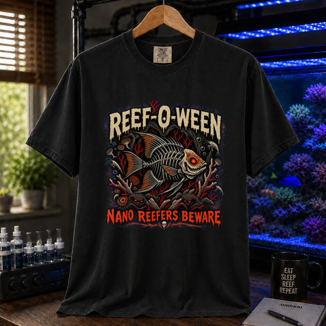 Saltwater aquarium graphic t-shirt design featuring dripping cream and orange typography reading Reef-O-Ween and Nano Reefers Beware with a glowing-eyed skeletal fish illustration and creepy corals, black crew neck tee