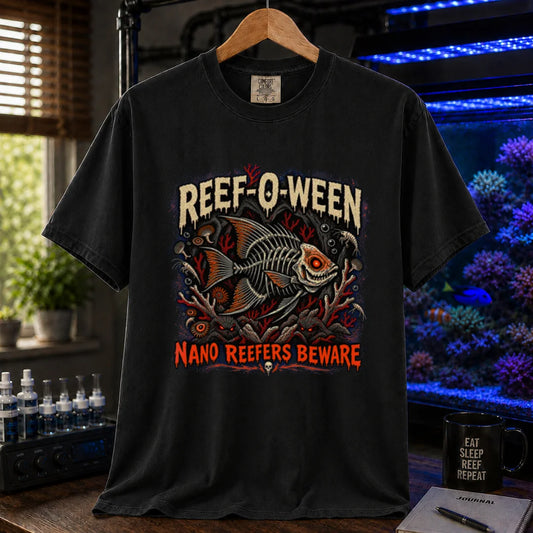 Saltwater aquarium graphic t-shirt design featuring dripping cream and orange typography reading Reef-O-Ween and Nano Reefers Beware with a glowing-eyed skeletal fish illustration and creepy corals, black crew neck tee