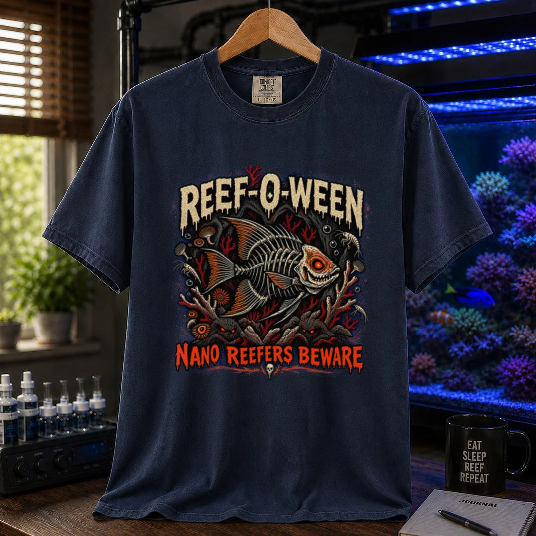 Saltwater aquarium graphic t-shirt design featuring dripping cream and orange typography reading Reef-O-Ween and Nano Reefers Beware with a glowing-eyed skeletal fish illustration and creepy corals, navy crew neck tee