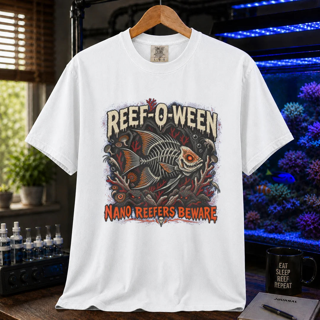 Saltwater aquarium graphic t-shirt design featuring dripping cream and orange typography reading Reef-O-Ween and Nano Reefers Beware with a glowing-eyed skeletal fish illustration and creepy corals, white crew neck tee