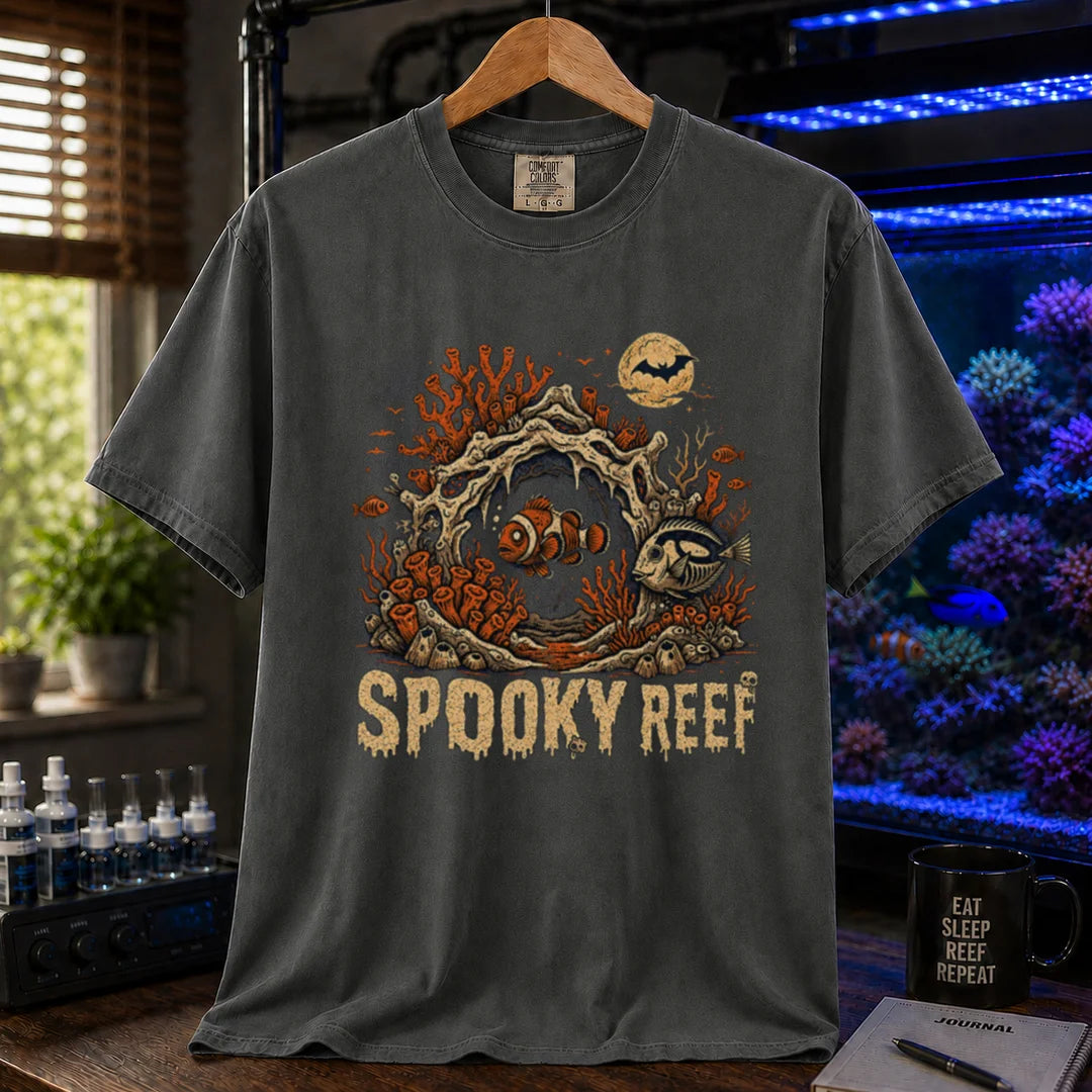 Saltwater aquarium graphic t-shirt design featuring dripping cream typography reading Spooky Reef with a spooky underwater scene featuring skeletal coral, a full moon with a bat, and eerie fish illustrations, dark grey crew neck tee