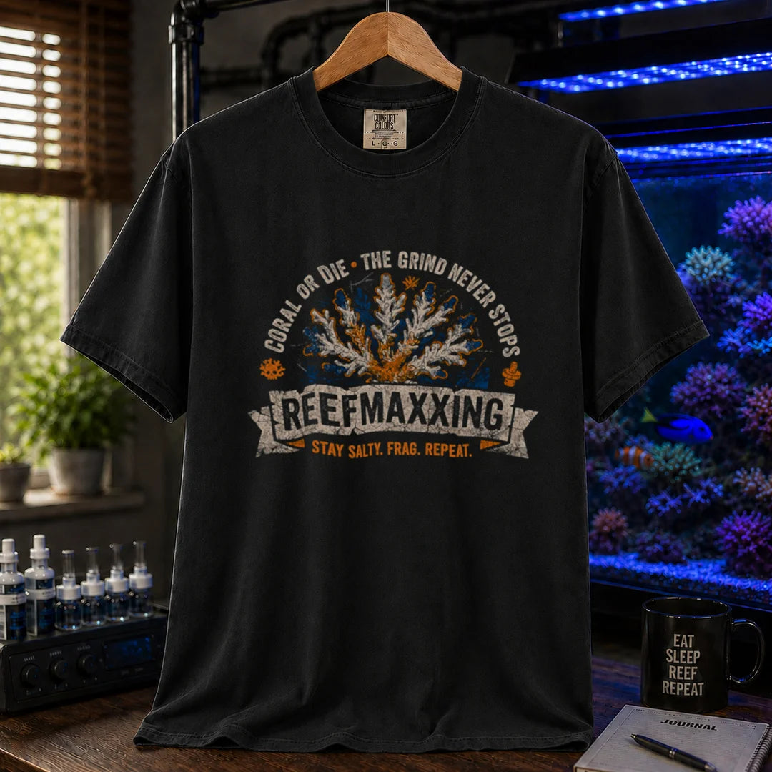 Saltwater aquarium graphic t-shirt design featuring a distressed vintage design reading Reefmaxxxing, Coral Or Die, and Stay Salty. Frag. Repeat. with a central coral graphic on a black tee