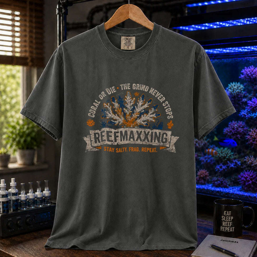 Saltwater aquarium graphic t-shirt design featuring a distressed vintage design reading Reefmaxxxing, Coral Or Die, and Stay Salty. Frag. Repeat. with a central coral graphic on a dark grey tee