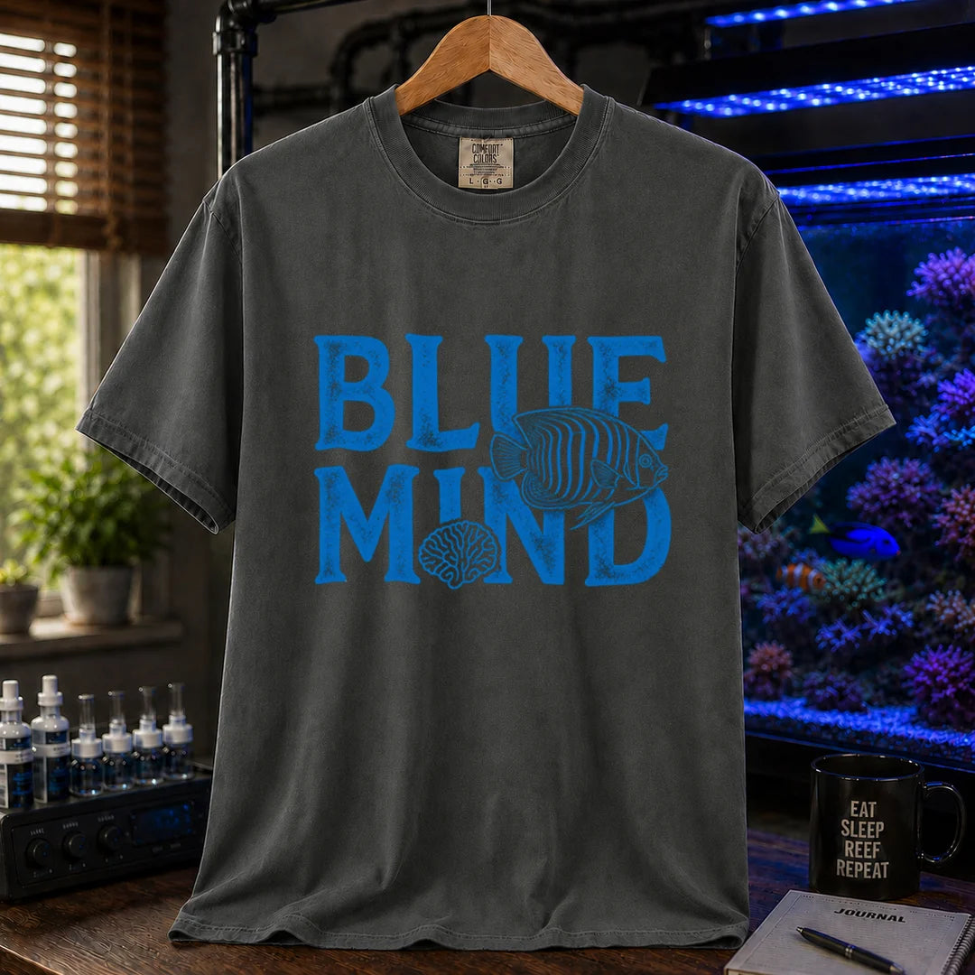 Saltwater aquarium graphic t-shirt design featuring distressed blue typography reading Blue Mind with an angelfish and brain coral illustration on a dark grey tee