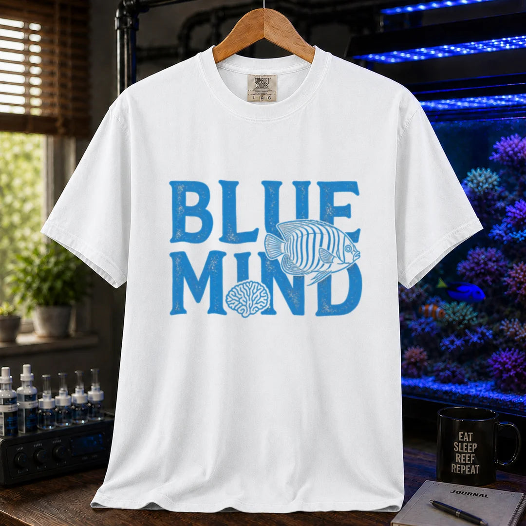 Saltwater aquarium graphic t-shirt design featuring distressed blue typography reading Blue Mind with an angelfish and brain coral illustration on a white tee