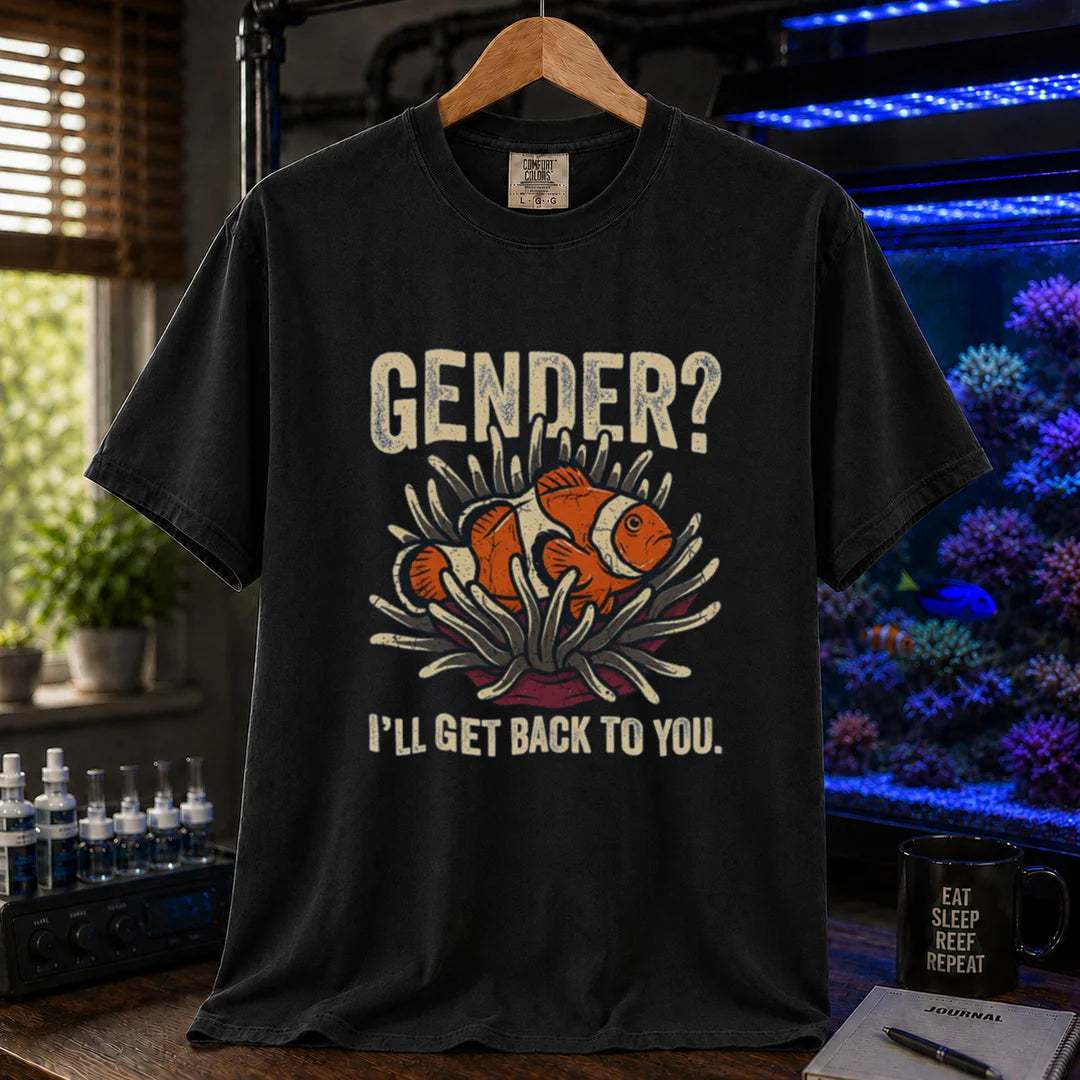 Saltwater aquarium graphic t-shirt design featuring distressed typography reading Gender? I'll Get Back To You with a central illustration of a clownfish in an anemone on a black tee