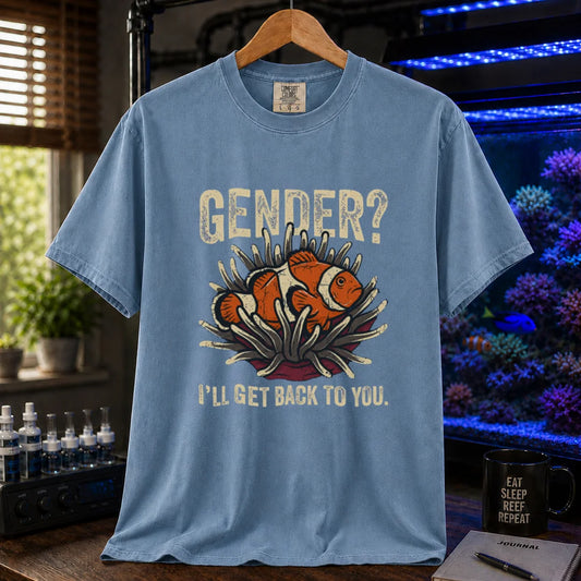 Saltwater aquarium graphic t-shirt design featuring distressed typography reading Gender? I'll Get Back To You with a central illustration of a clownfish in an anemone on a blue tee