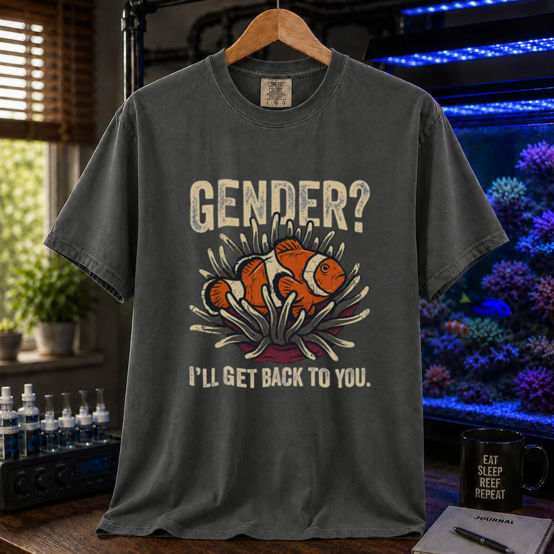 Saltwater aquarium graphic t-shirt design featuring distressed typography reading Gender? I'll Get Back To You with a central illustration of a clownfish in an anemone on a dark grey tee