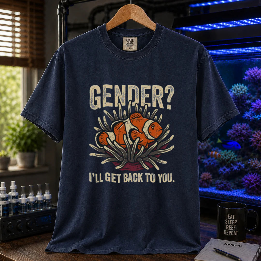 Saltwater aquarium graphic t-shirt design featuring distressed typography reading Gender? I'll Get Back To You with a central illustration of a clownfish in an anemone on a NAVY tee
