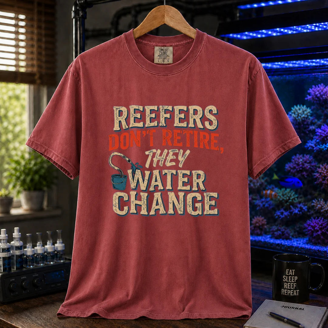 Saltwater aquarium graphic t-shirt design featuring distressed typography reading Reefers Don't Retire, They Water Change with a bucket and siphon illustration on a maroon, red tee