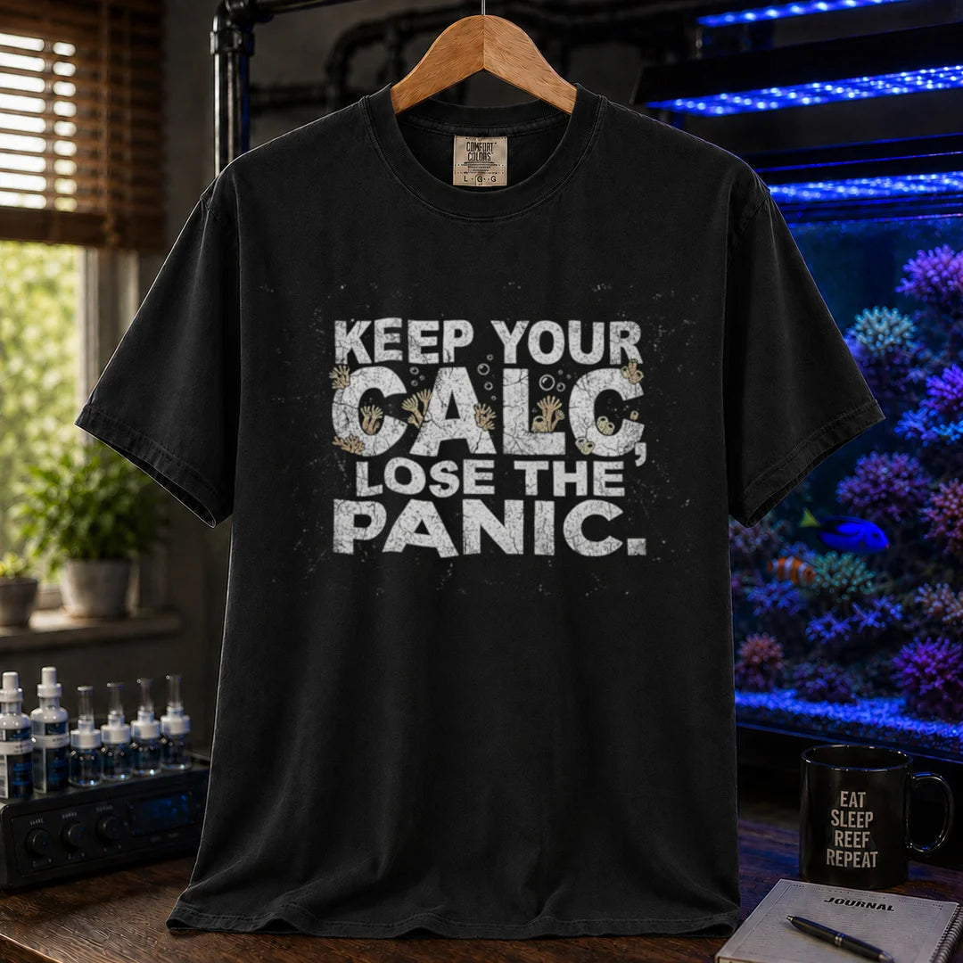 Saltwater aquarium graphic t-shirt design featuring distressed white typography reading Keep Your Calc, Lose The Panic with coral details inside the lettering on a BLACK tee