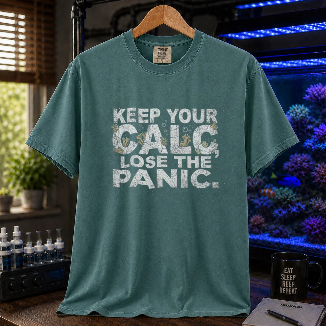 Saltwater aquarium graphic t-shirt design featuring distressed white typography reading Keep Your Calc, Lose The Panic with coral details inside the lettering on a green tee