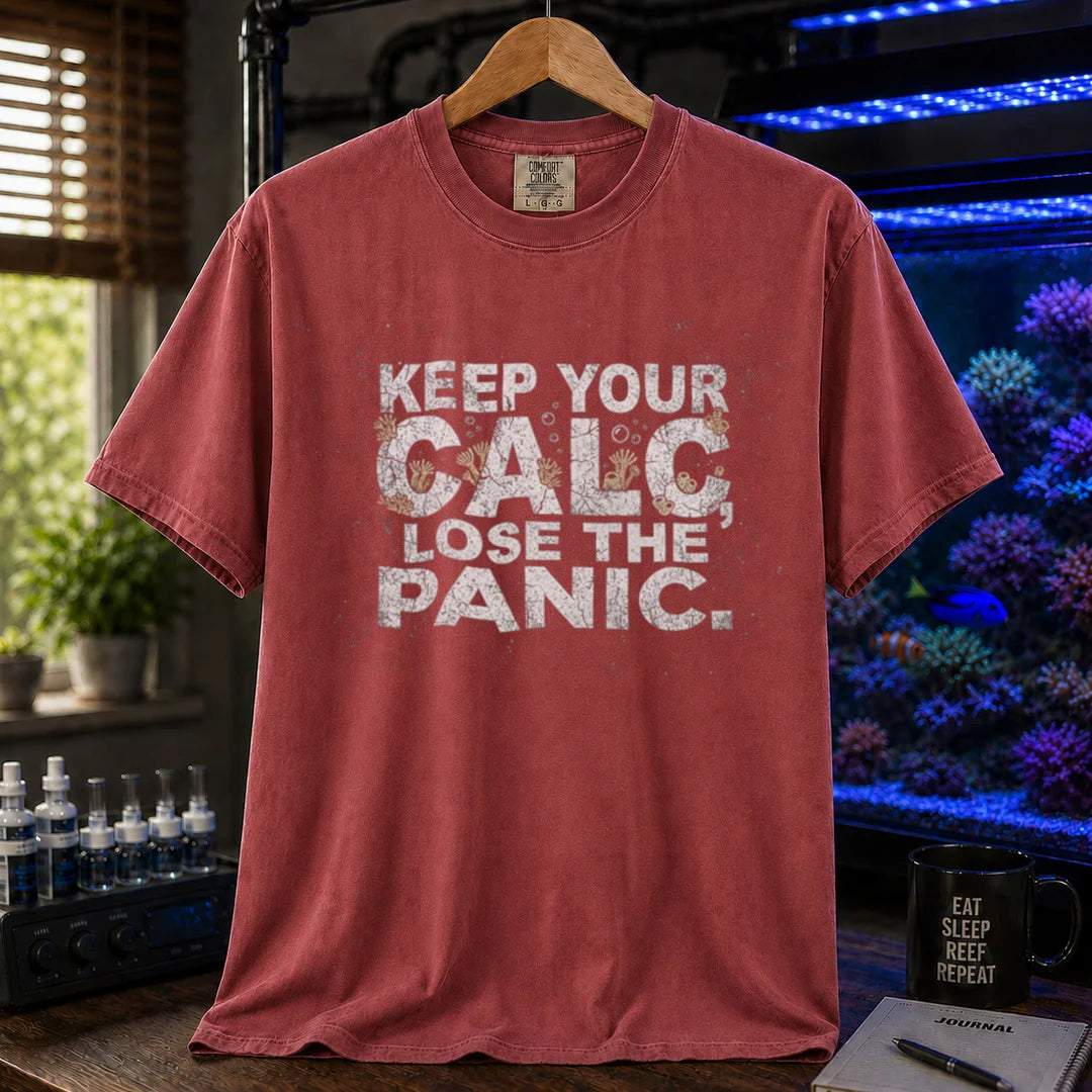 Saltwater aquarium graphic t-shirt design featuring distressed white typography reading Keep Your Calc, Lose The Panic with coral details inside the lettering on a maroon, red tee