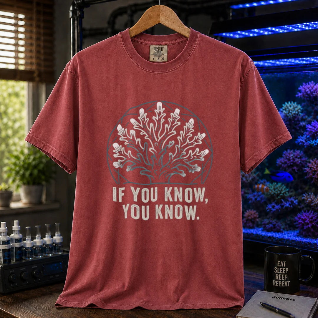 Saltwater aquarium graphic t-shirt design featuring a minimalist line-art coral colony inside a geometric frame with typography reading If You Know, You Know on a maroon, red tee