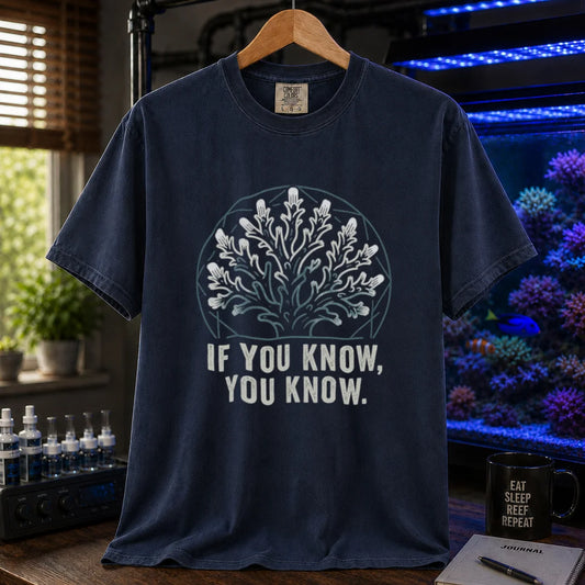 Saltwater aquarium graphic t-shirt design featuring a minimalist line-art coral colony inside a geometric frame with typography reading If You Know, You Know on a navy tee