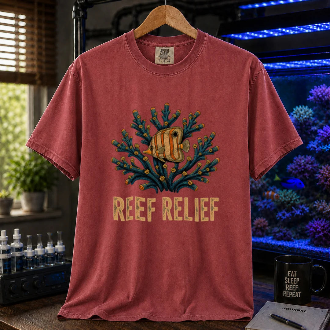 Saltwater aquarium graphic t-shirt design featuring a butterflyfish nestled in a blue coral colony with distressed typography reading Reef Relief on a maroon, red tee