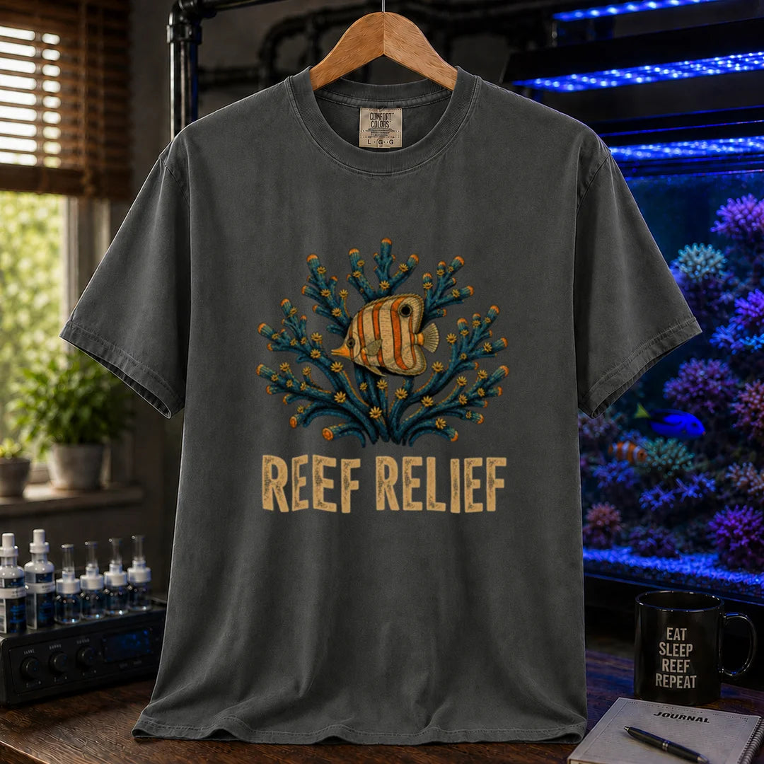 Saltwater aquarium graphic t-shirt design featuring a butterflyfish nestled in a blue coral colony with distressed typography reading Reef Relief on a dark grey tee