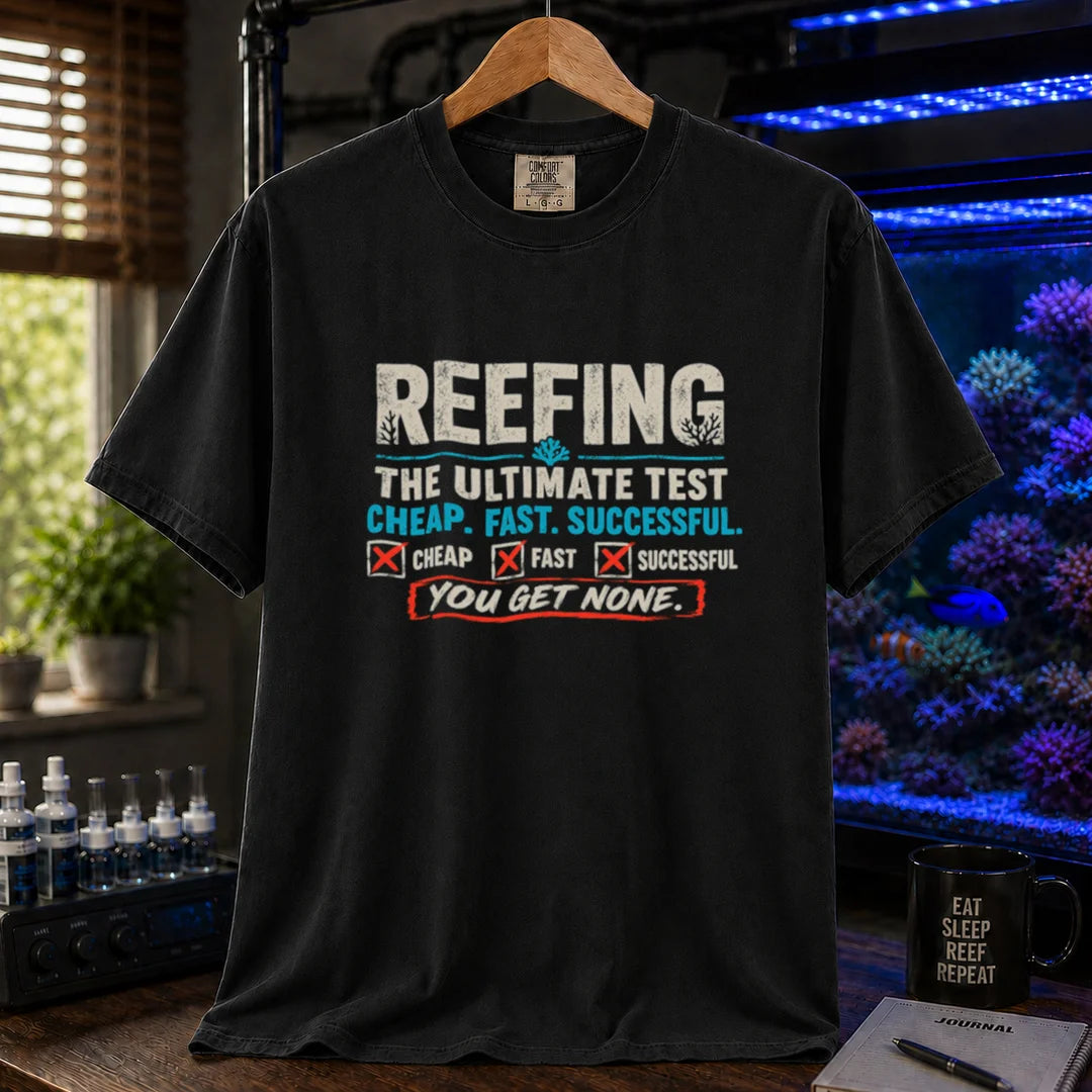 Saltwater aquarium graphic t-shirt design featuring distressed typography reading Reefing The Ultimate Test Cheap. Fast. Successful. with checkbox symbols and the punchline You Get None on a black tee