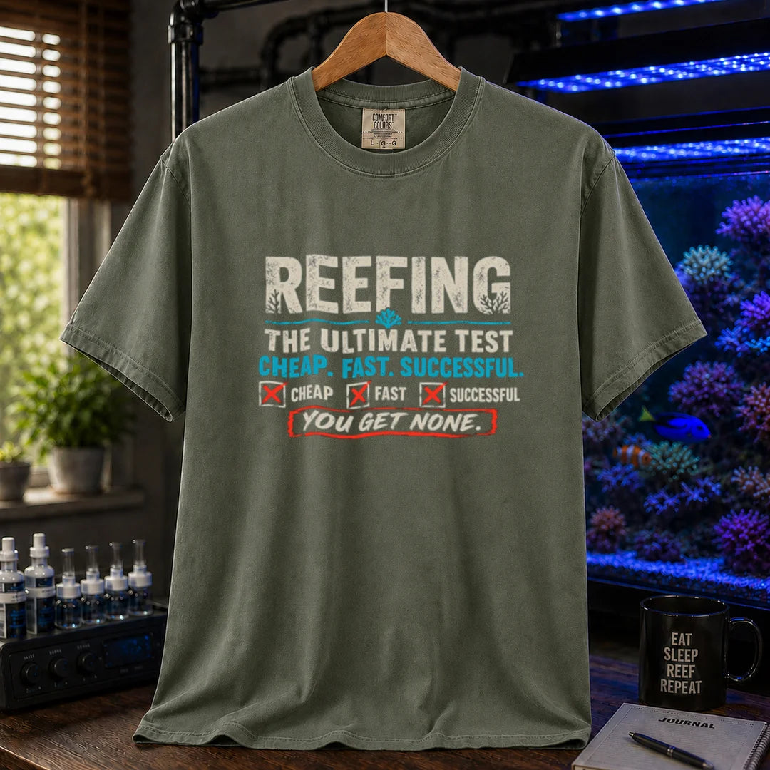 Saltwater aquarium graphic t-shirt design featuring distressed typography reading Reefing The Ultimate Test Cheap. Fast. Successful. with checkbox symbols and the punchline You Get None on a military green tee