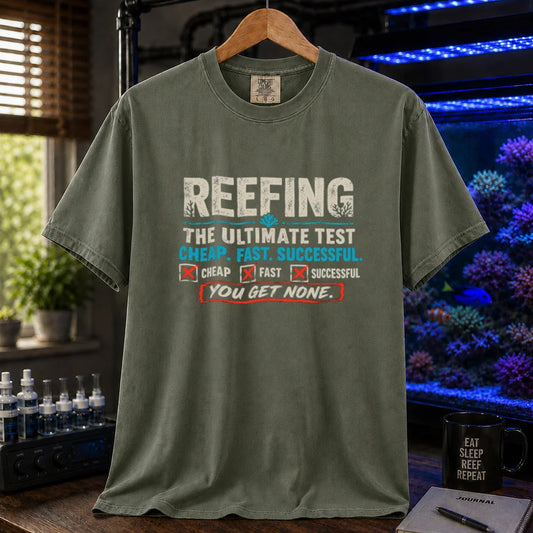 Saltwater aquarium graphic t-shirt design featuring distressed typography reading Reefing The Ultimate Test Cheap. Fast. Successful. with checkbox symbols and the punchline You Get None on a military green tee