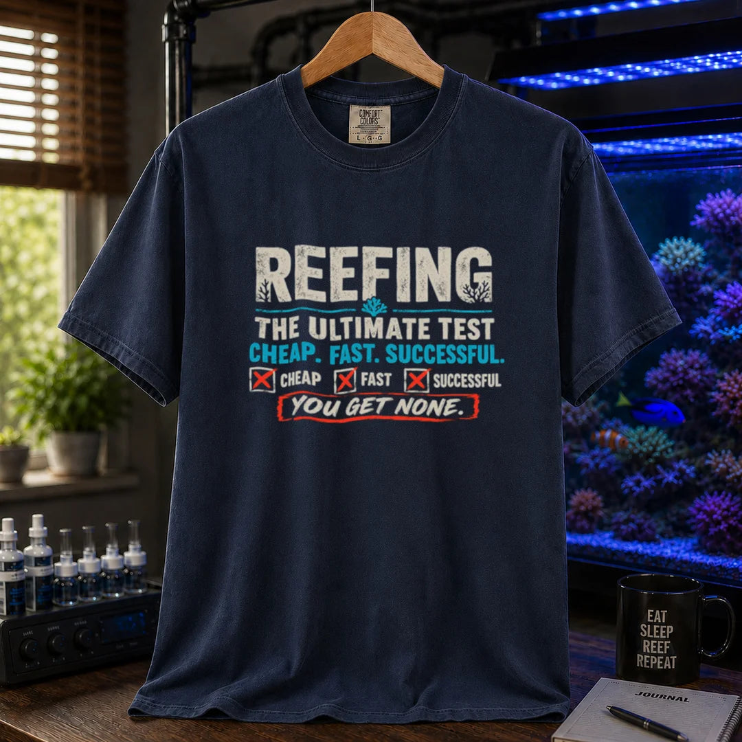 Saltwater aquarium graphic t-shirt design featuring distressed typography reading Reefing The Ultimate Test Cheap. Fast. Successful. with checkbox symbols and the punchline You Get None on a NAVY tee