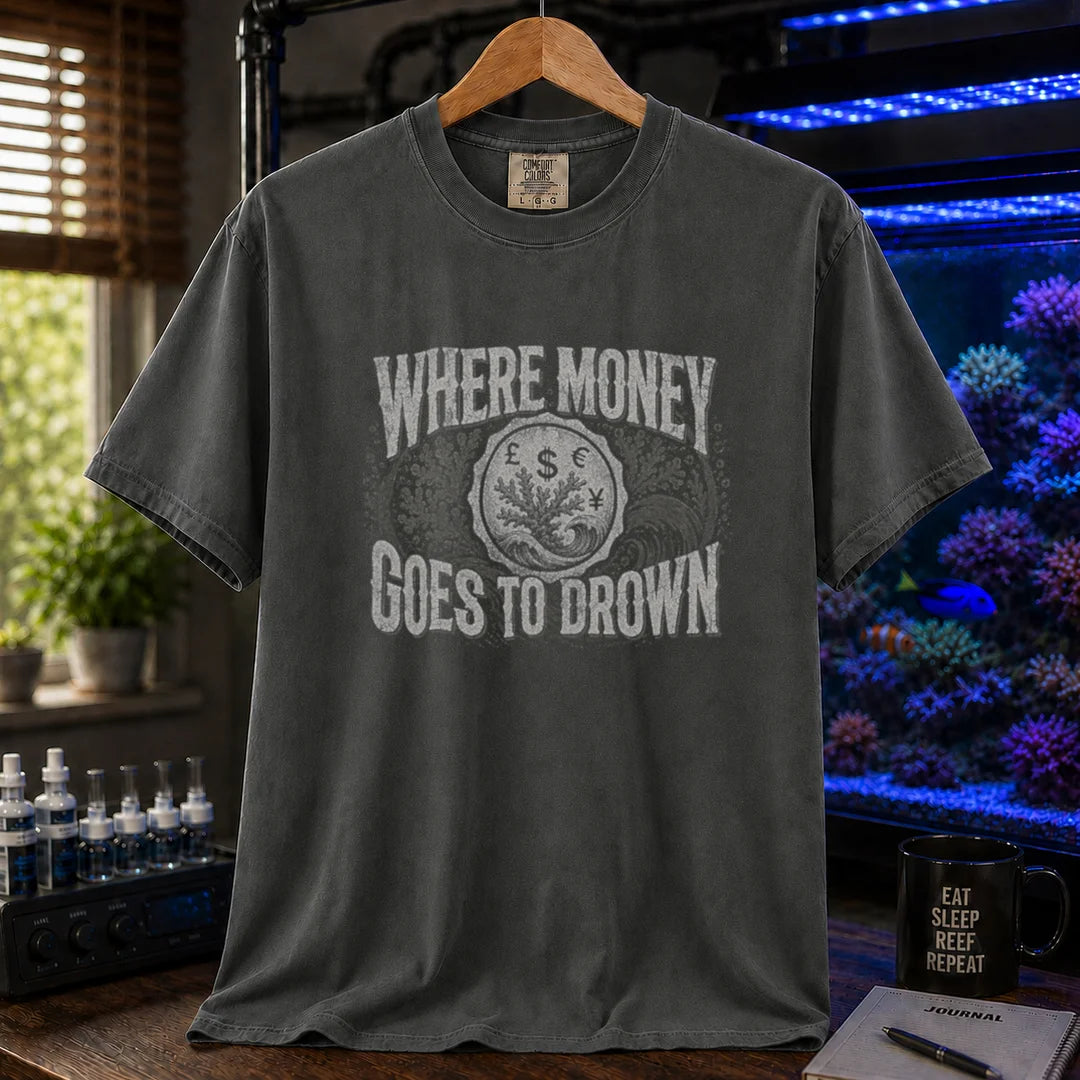 Saltwater aquarium graphic t-shirt design featuring distressed typography reading Where Money Goes To Drown with a central currency symbol and coral emblem on a dark grey tee