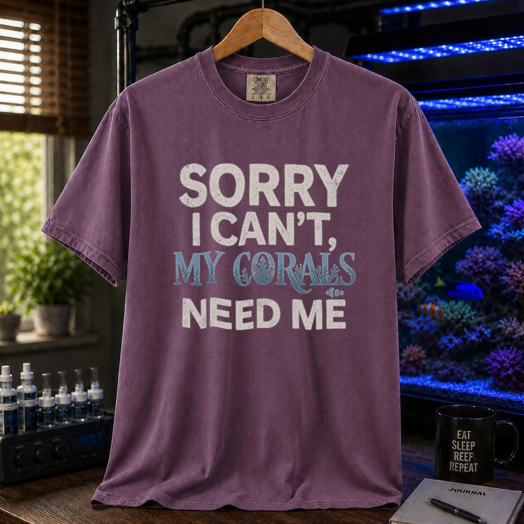 Saltwater aquarium graphic t-shirt design featuring distressed typography reading Sorry I Can't, My Corals Need Me with integrated coral silhouettes on a purple tee