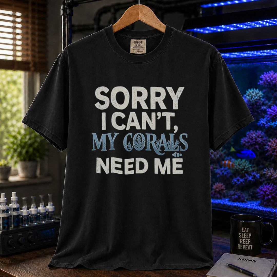 Saltwater aquarium graphic t-shirt design featuring distressed typography reading Sorry I Can't, My Corals Need Me with integrated coral silhouettes on a BLACK tee