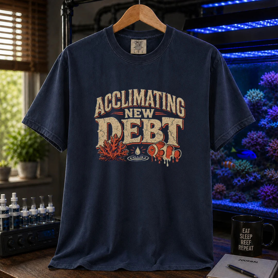 Saltwater aquarium graphic t-shirt design featuring distressed typography reading Acclimating New Debt with coral, water droplet, and clownfish illustrations on a NAVY tee