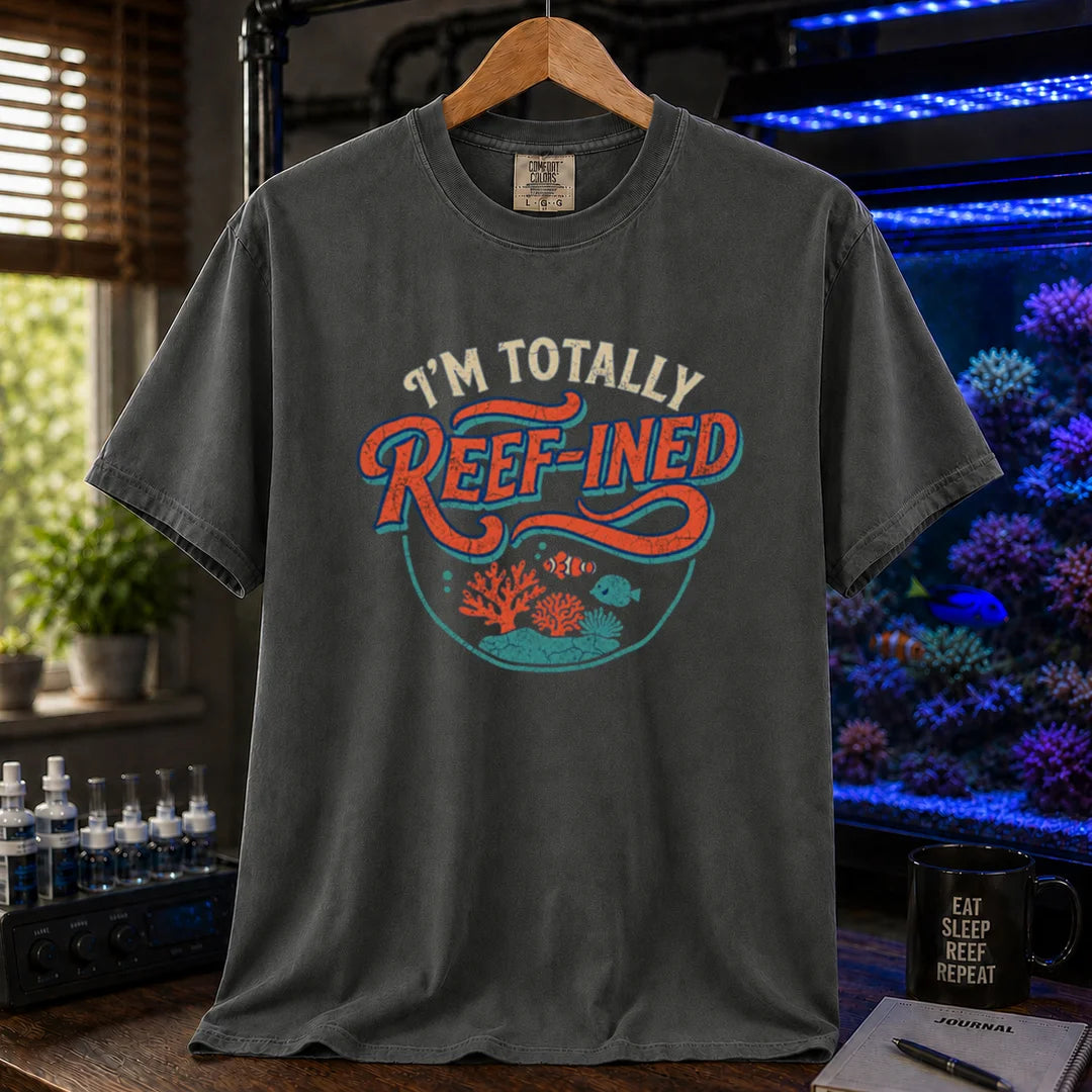 Saltwater aquarium graphic t-shirt design featuring distressed typography reading I'm Totally Reef-Ined with a circular coral and fish scene on a dark grey tee