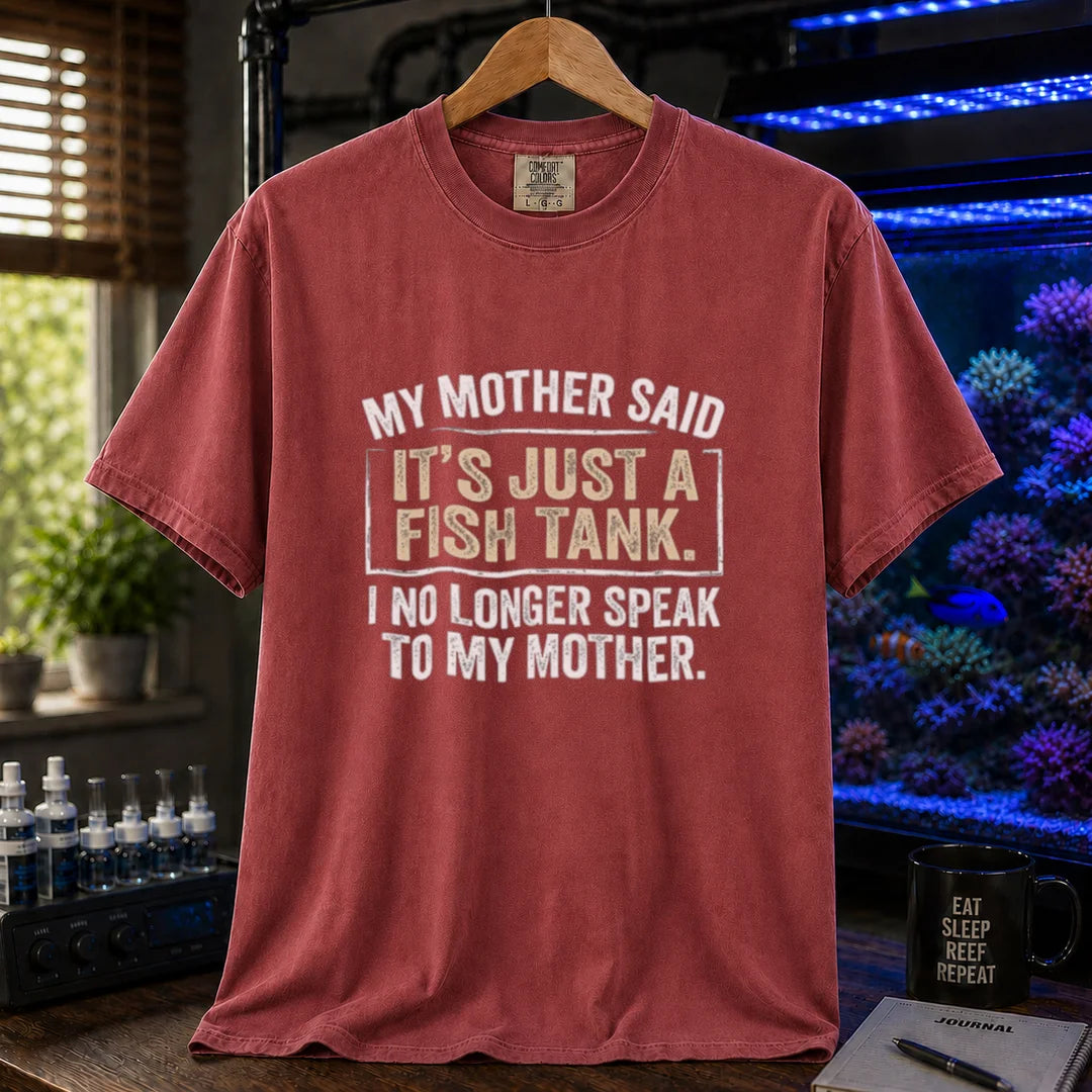 Saltwater aquarium graphic t-shirt featuring distressed white block typography reading My Mother Said It's Just A Fish Tank. I No Longer Speak To My Mother. printed on a maroon, red tee displayed in a reef room setting