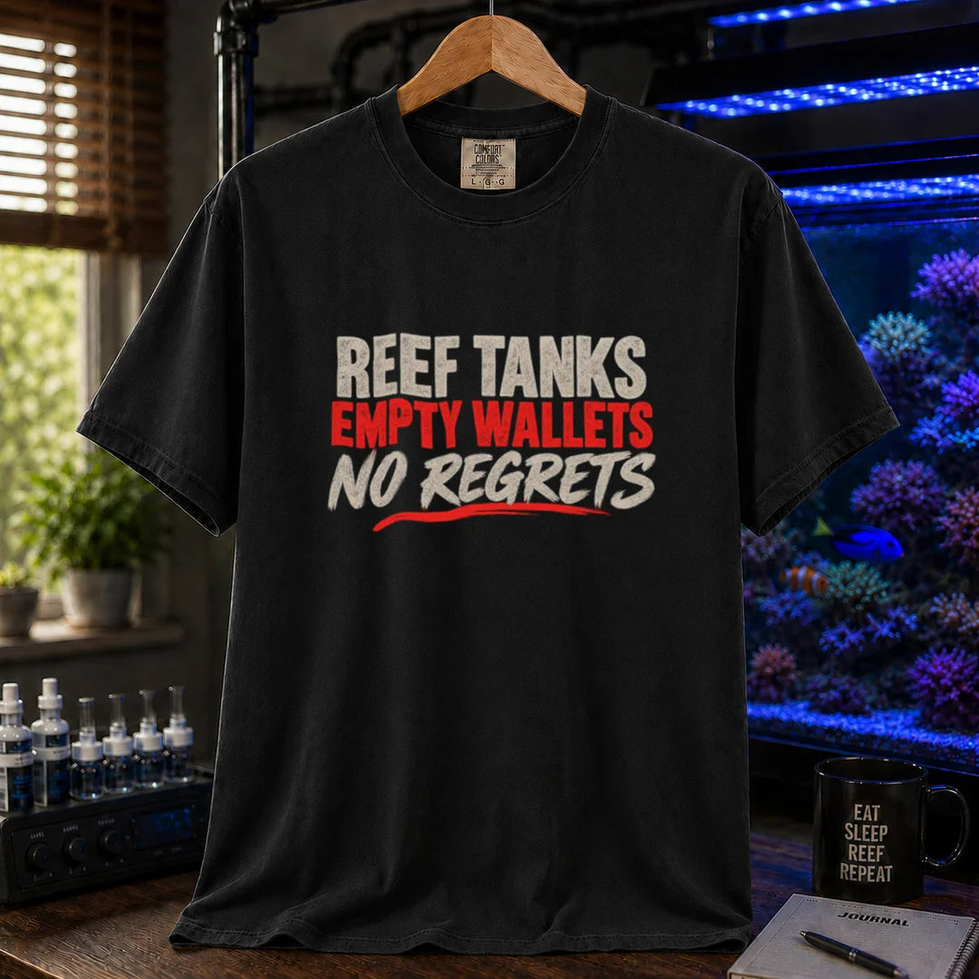 Saltwater aquarium graphic t-shirt featuring distressed cream and red typography reading Reef Tanks, Empty Wallets, No Regrets printed on a black tee displayed in a reef room setting