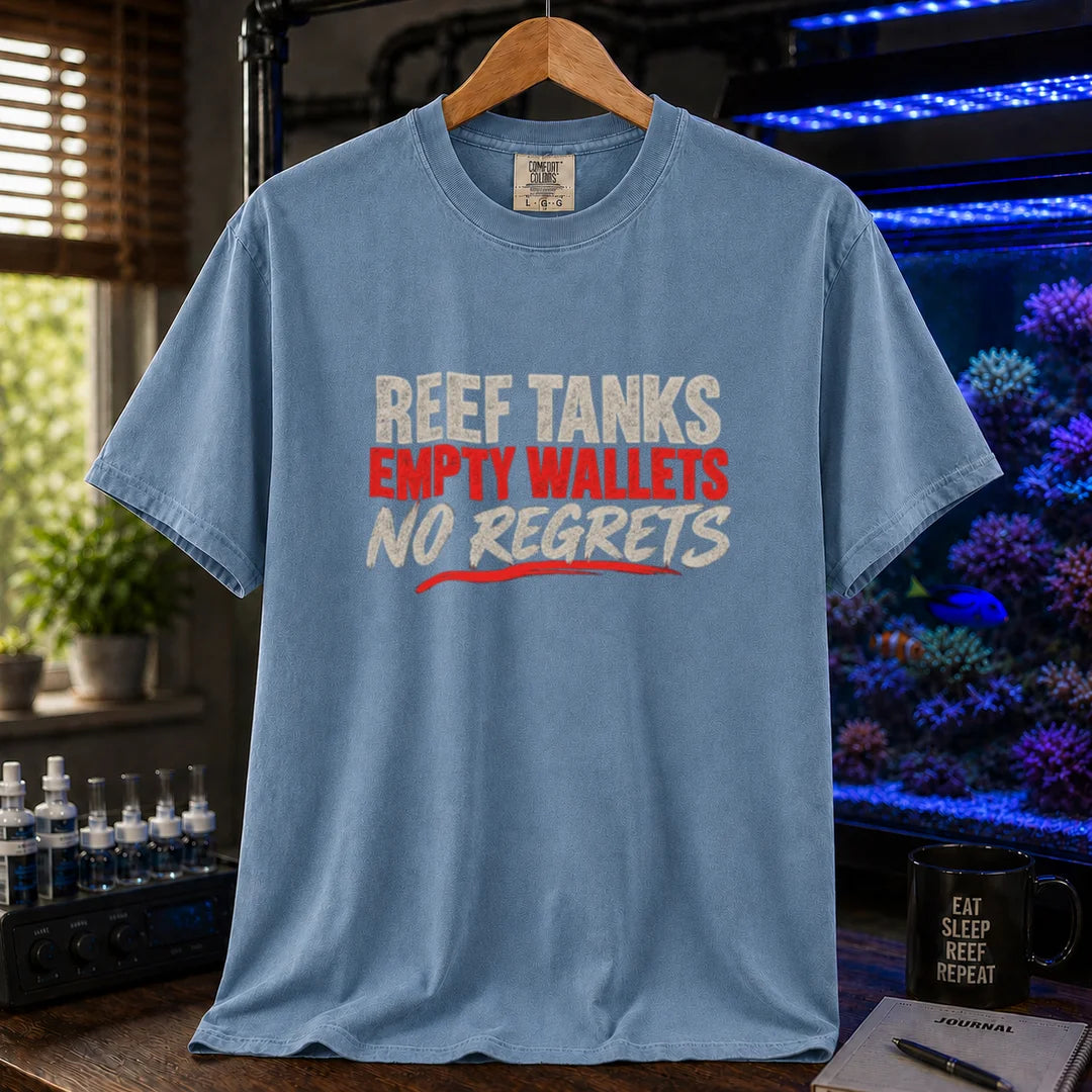 Saltwater aquarium graphic t-shirt featuring distressed cream and red typography reading Reef Tanks, Empty Wallets, No Regrets printed on a blue tee displayed in a reef room setting