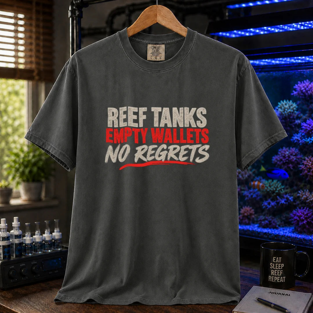 Saltwater aquarium graphic t-shirt featuring distressed cream and red typography reading Reef Tanks, Empty Wallets, No Regrets printed on a dark grey tee displayed in a reef room setting
