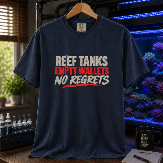 Saltwater aquarium graphic t-shirt featuring distressed cream and red typography reading Reef Tanks, Empty Wallets, No Regrets printed on a navy tee displayed in a reef room setting