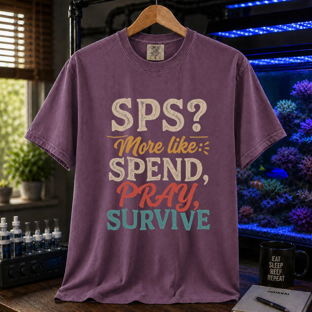 Saltwater aquarium graphic t-shirt featuring distressed vintage typography reading SPS? More Like: Spend, Pray, Survive printed on a purple tee displayed in a reef room setting