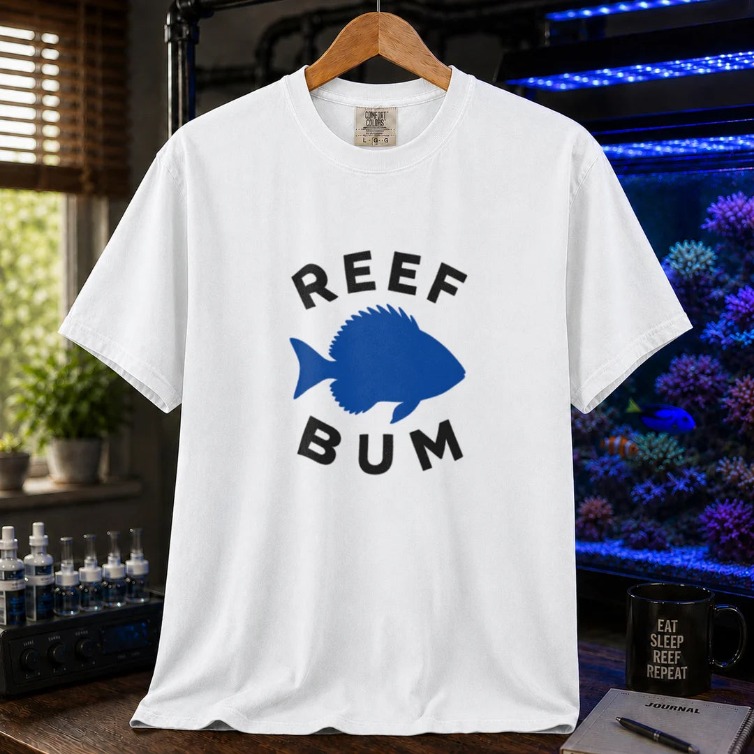 Saltwater aquarium graphic t-shirt featuring bold black typography reading Reef Bum arched around a solid blue silhouette of a fish on a white background