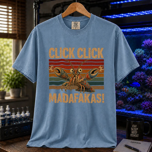 Saltwater aquarium graphic t-shirt featuring a pistol shrimp snapping its claws over vintage sunset stripes with text reading Click Click Madafakas! on a blue shirt