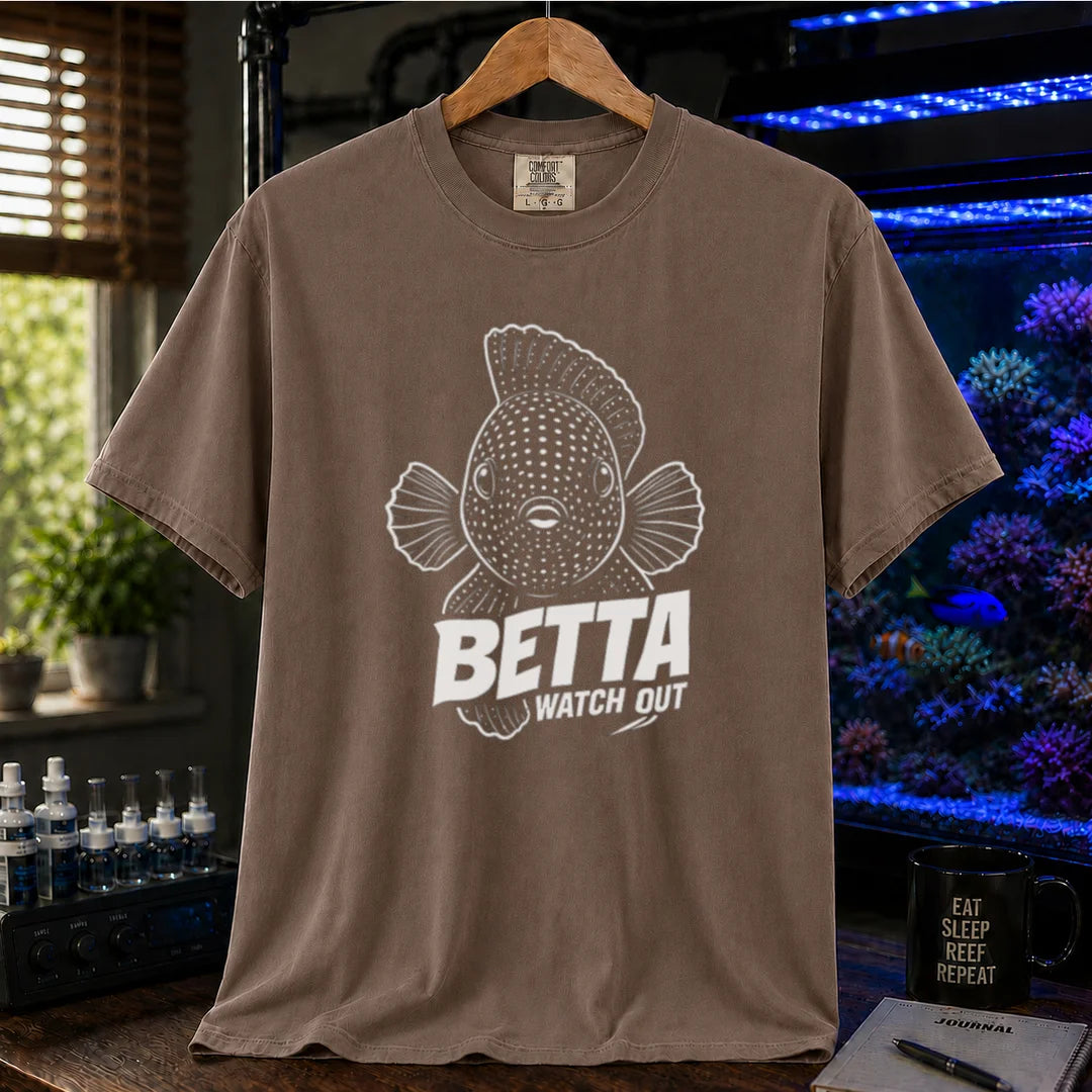 Saltwater aquarium graphic t-shirt featuring a front-facing spotted fish illustration and white typography reading Betta Watch Out on a brown shirt