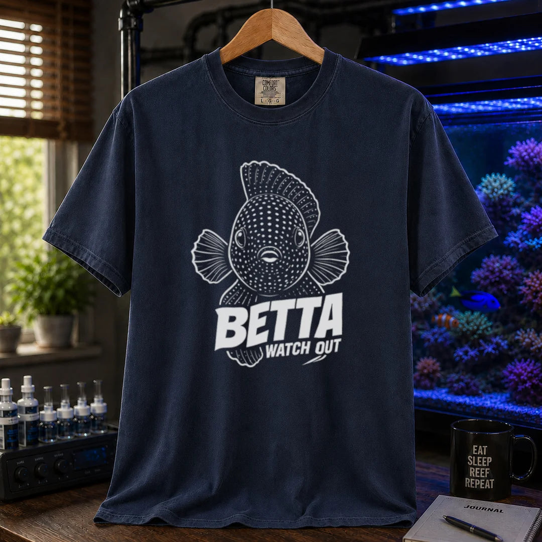 Saltwater aquarium graphic t-shirt featuring a front-facing spotted fish illustration and white typography reading Betta Watch Out on a navy shirt