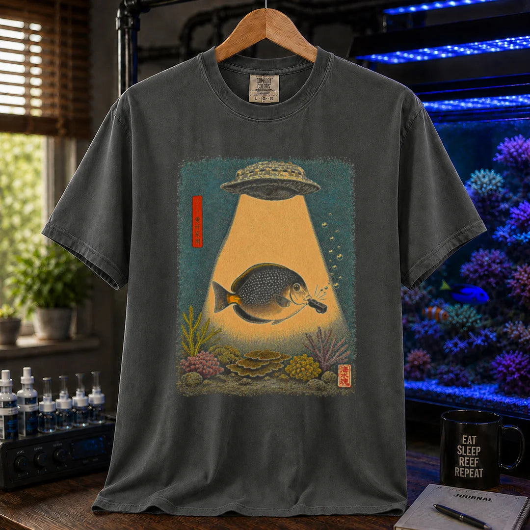 Saltwater aquarium graphic t-shirt featuring a vintage woodblock print style UFO abducting a reef fish with a tractor beam over coral on a dark grey shirt